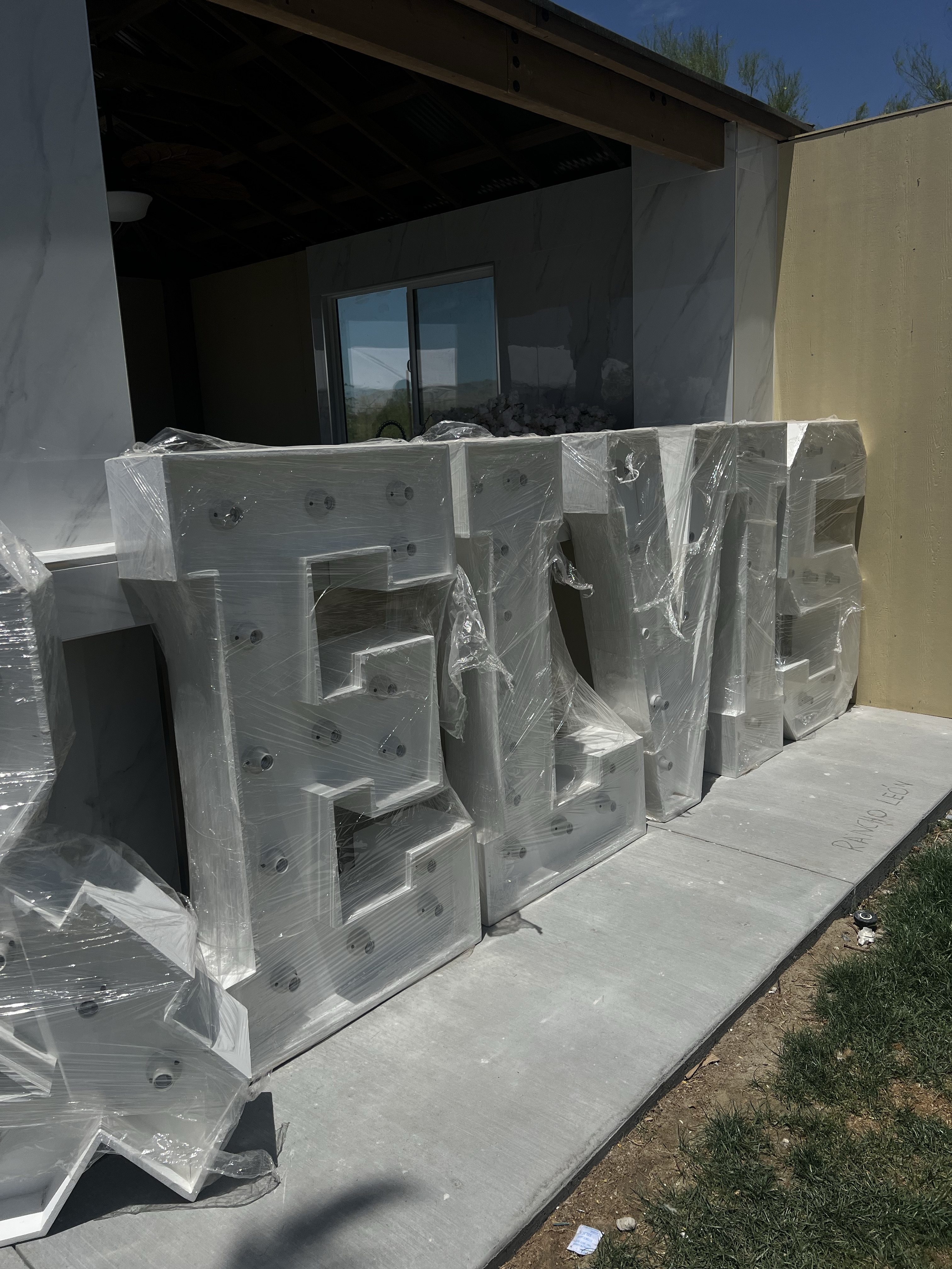 Giant marquee letters being prepared for an event setup